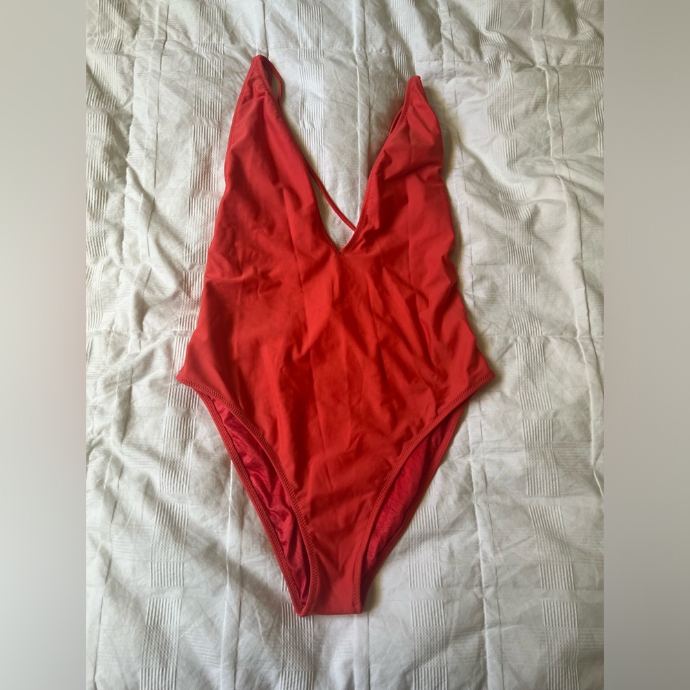 Coral colored Volcam strappy high cut one piece bathing suit